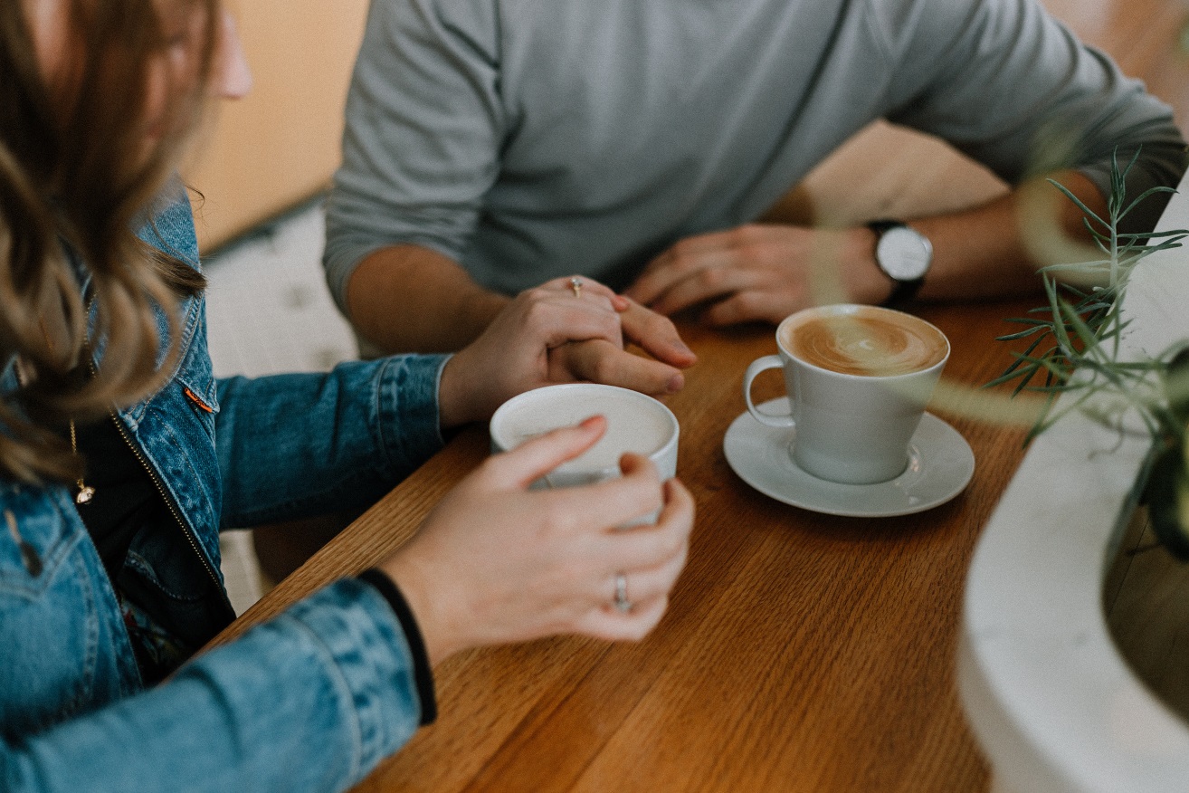 people on a date having fun and drinking coffee