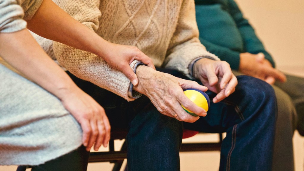 younger person taking care of elderly relative