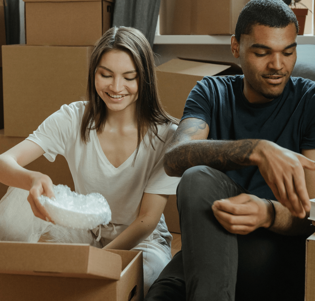 happy people packing boxes and decluttering